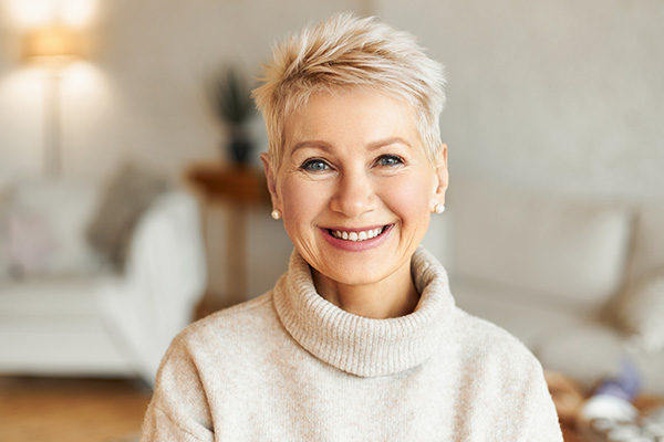 A woman with short hair smiling at the camera.